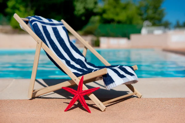 Beach chair near swimming pool — Stock Photo, Image