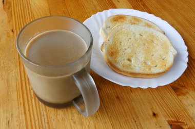 Cup of coffee with milk and two toasted bread slices clipart