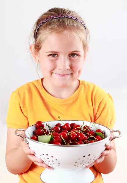 Child holding a bowl of fresh cherries — Stock Photo, Image