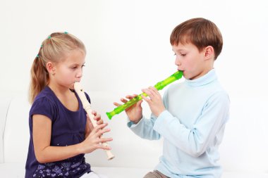 Kids playing flute clipart