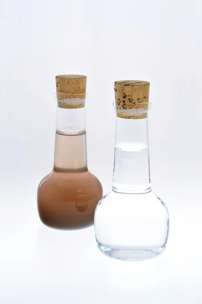 Sample of clean and dirty water isolated — Stock Photo, Image