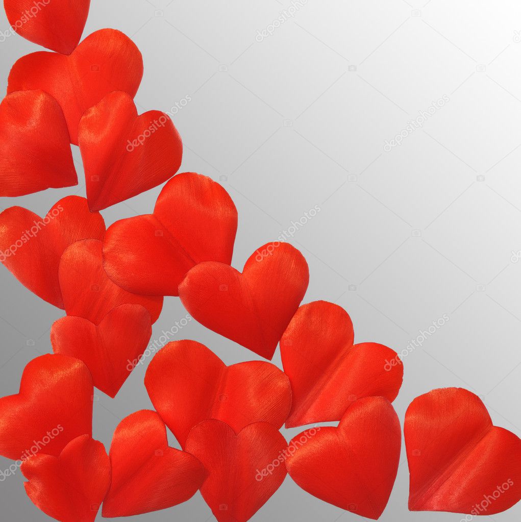 Petals in heart shape over gray background - frame. Clipping path included