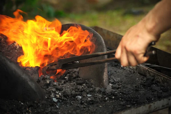 Blacksmith heating up iron - detail — Stock Photo, Image