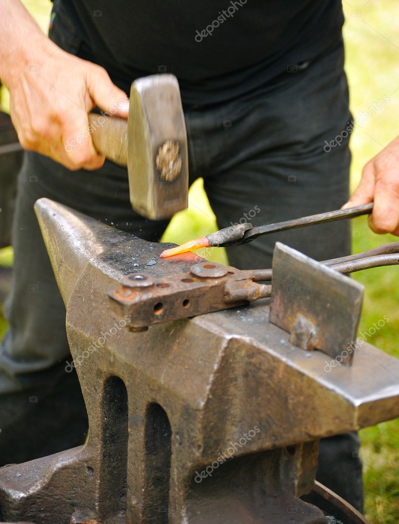 Blacksmith hammering hot steel on anvil — Stock Photo © brozova 5949174