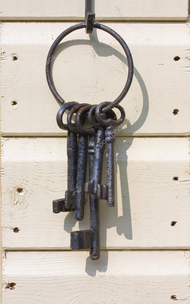Old iron keys on a wooden shed wall