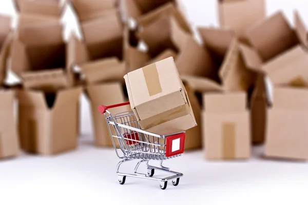 Shopping cart with many open boxes — Stock Photo, Image