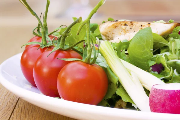 stock image Cherry tomatoes on a salad plate close up