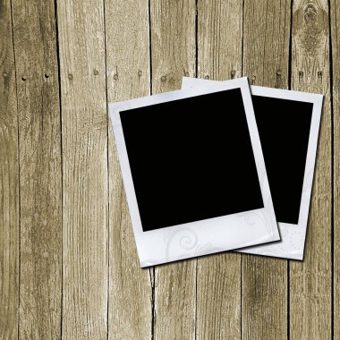 Photo frames on wooden texture clipart