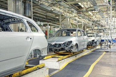 Cars in a row at car plant clipart