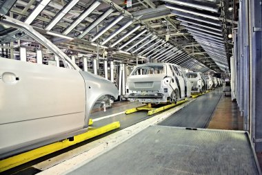 Cars in a row at car plant clipart