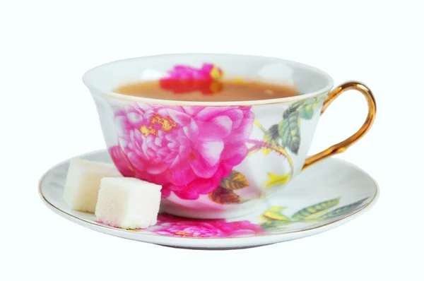 A cup of tea and sugar in isolation on a white background — Stock Photo, Image
