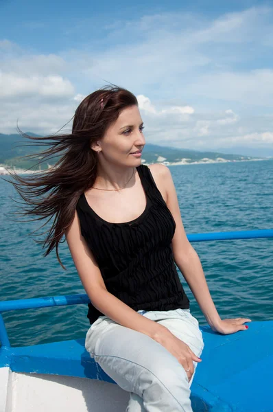 stock image A beautiful young woman on a yacht at sea