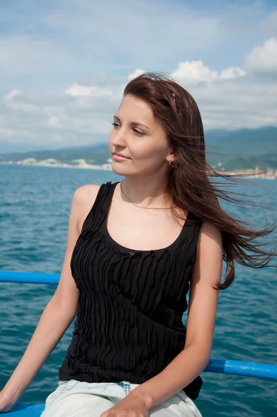 stock image A beautiful young woman on a yacht at sea