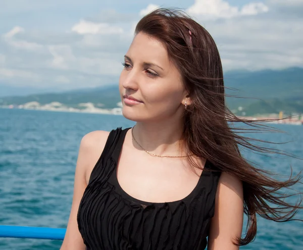 stock image A beautiful young woman on a yacht at sea