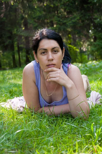 Stock image Beautiful middle-aged woman lying on grass