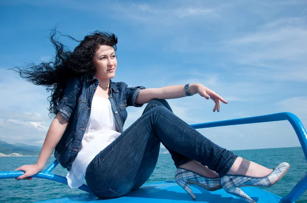 stock image A beautiful young woman on a yacht at sea