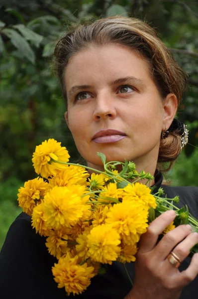 노란 꽃을 가진 여자의 초상화 — 스톡 사진
