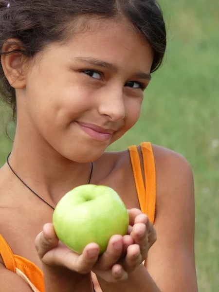 A beautiful girl with a delicious green apple — Stock Photo, Image