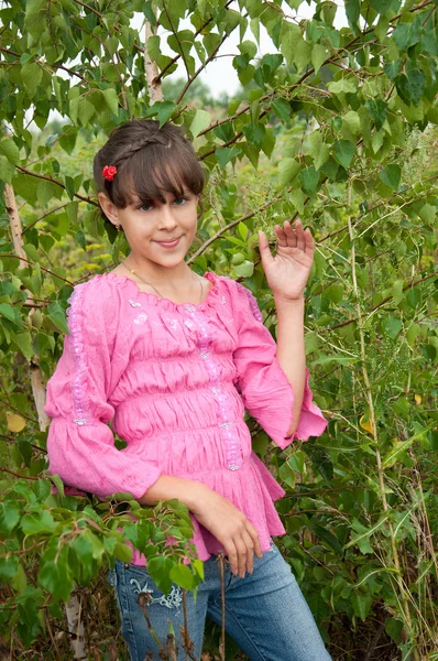 stock image The Russian girl stands near the birch