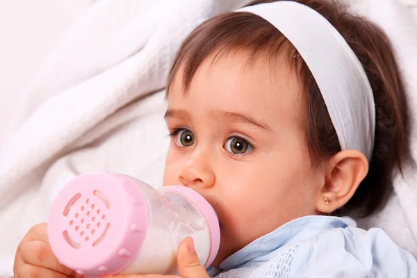 Baby girl with bottle — Stock Photo, Image