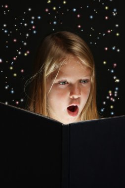 Young Girl Reading a Fantasy Book clipart