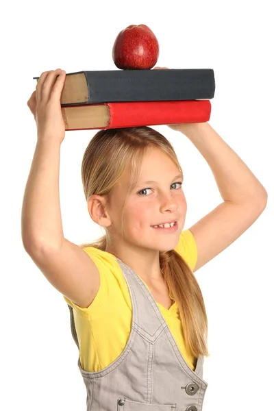 Söt flicka med böcker och äpple — Stockfoto