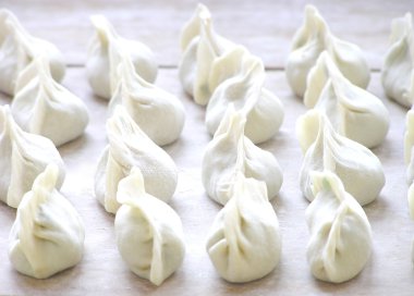 A lot of dumplings stand in a line. clipart