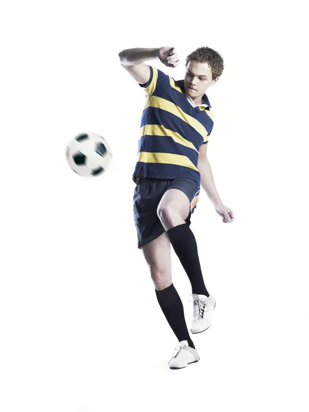 Strong athlete kicking the ball — Stock Photo, Image