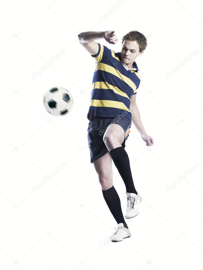Strong athlete kicking the ball