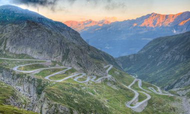 Old road with tight serpentines bends of the St. Gotthard pass clipart