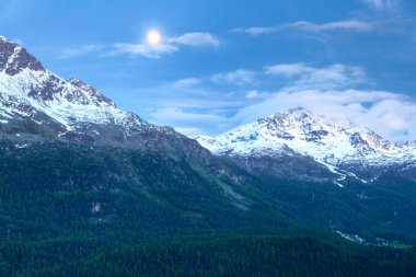 Alpine mountains in a monlit night clipart