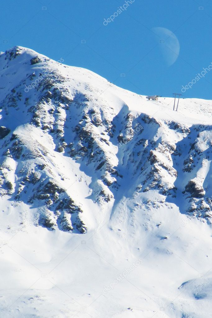 Skiing slopes at day with moon
