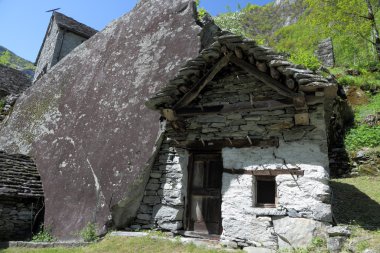 House build in rock in Ticino mountains clipart