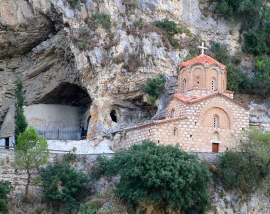 Byzantine style church in rock face clipart