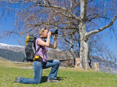 Pretty woman takes outdoor pictures clipart