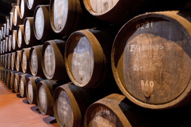 Port wine ages in barrels in cellar clipart