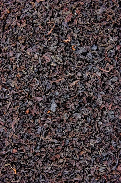 Gedetailleerde zwarte thee blad textuur achtergrond — Stockfoto