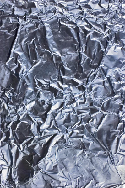 Abstrakt skrynkliga silver aluminiumfolie närbild bakgrund strukturer — Stockfoto