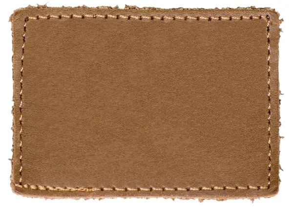 Etiqueta de etiqueta de cuero marrón beige en blanco natural Jeans, Aislado —  Fotos de Stock