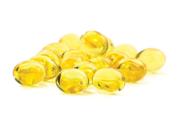Kapsułki olej żółty witamina zbliżenie makro na białym tle — Zdjęcie stockowe