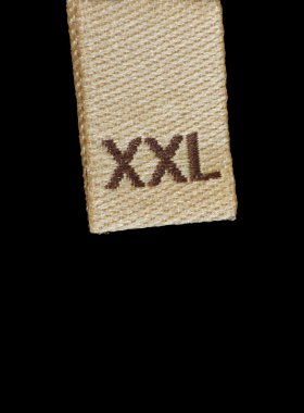 Macro of XXL size clothing label, large closeup isolated on black clipart