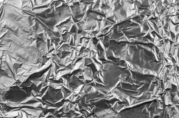 Abstracte verfrommeld zilver aluminiumfolie close-up achtergrond textur — Stockfoto