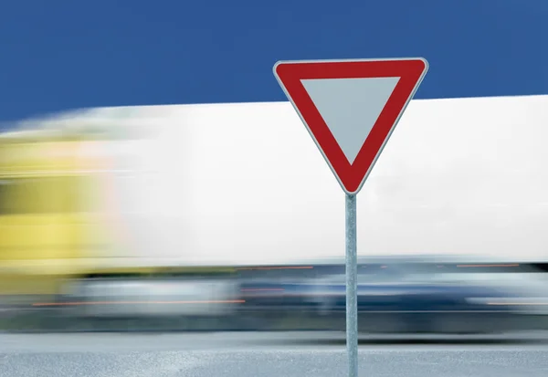 Give way yield traffic sign and truck — Stock Photo, Image