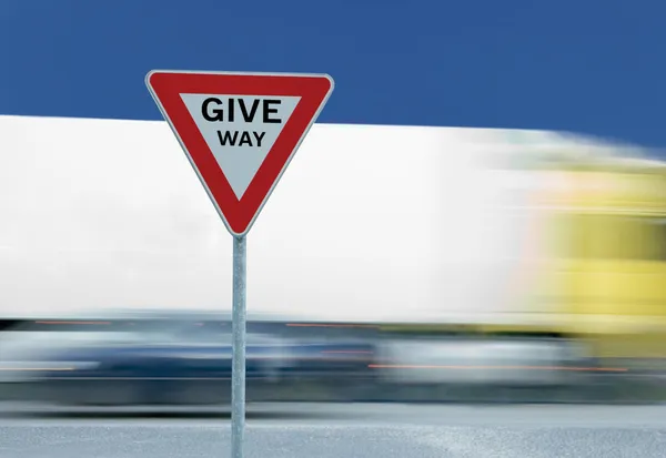 Give way yield traffic sign and truck — Stock Photo, Image