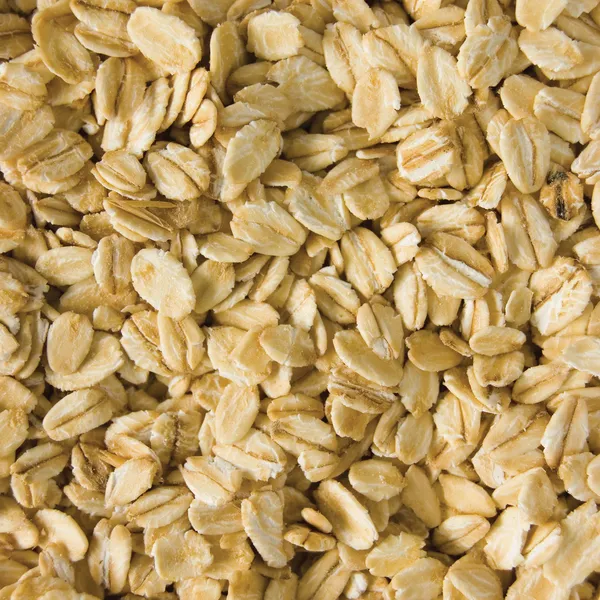 Oatmeal background, rolled raw oats macro closeup — Stock Photo, Image