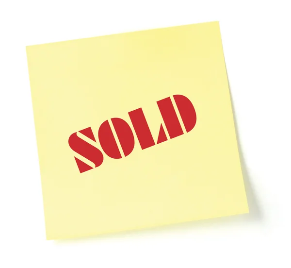 Sticky note indicating item is sold, yellow sticker — Stock Photo, Image