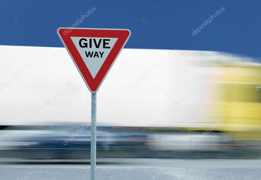 Give way yield traffic sign and truck