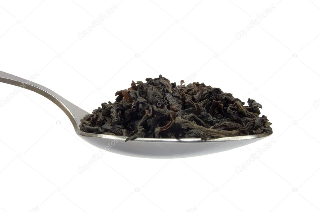 Teaspoon with loose black tea leaf, isolated spoon