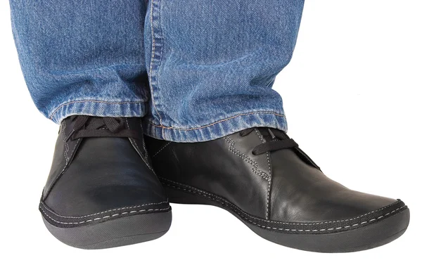 Black leather shoes, blue denim indigo jeans, casual men sneakers — Stock Photo, Image