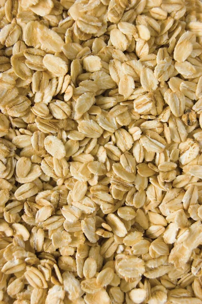 Oatmeal background, rolled raw oats macro closeup vertical — Stock Photo, Image